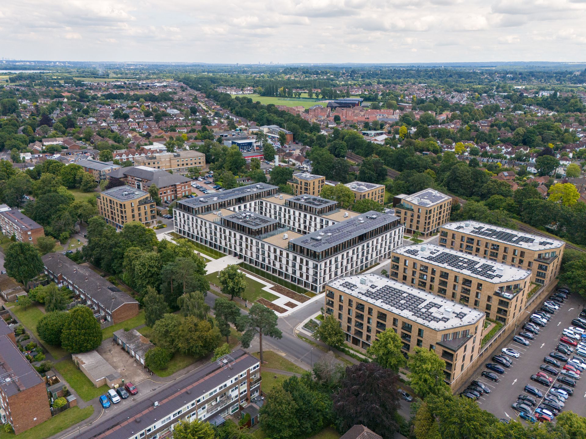 An aerial view of a city with lots of buildings and trees.