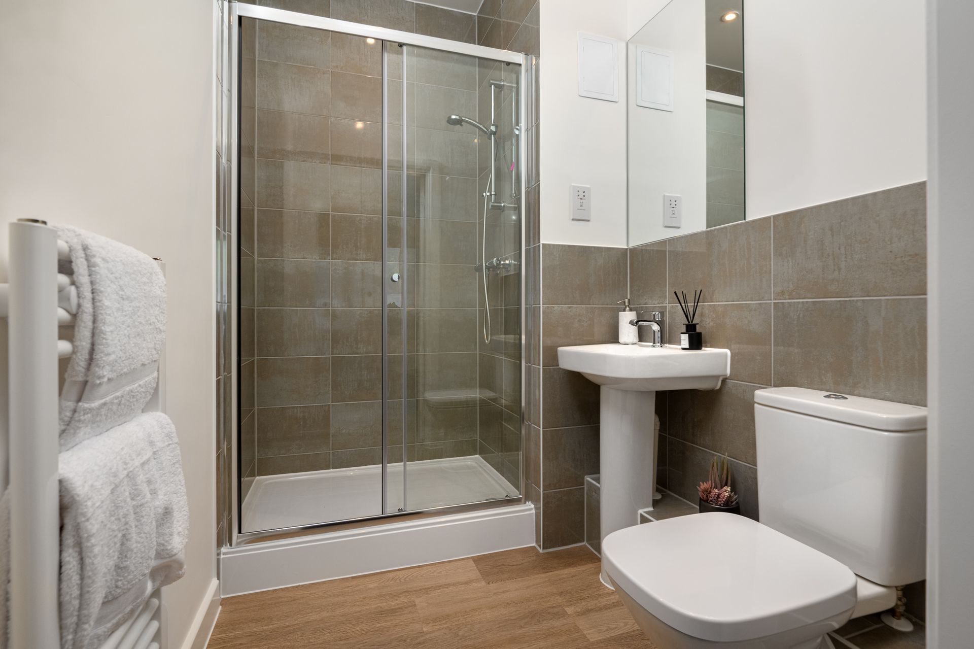 A bathroom with a toilet , sink , shower and mirror at Walton Court.