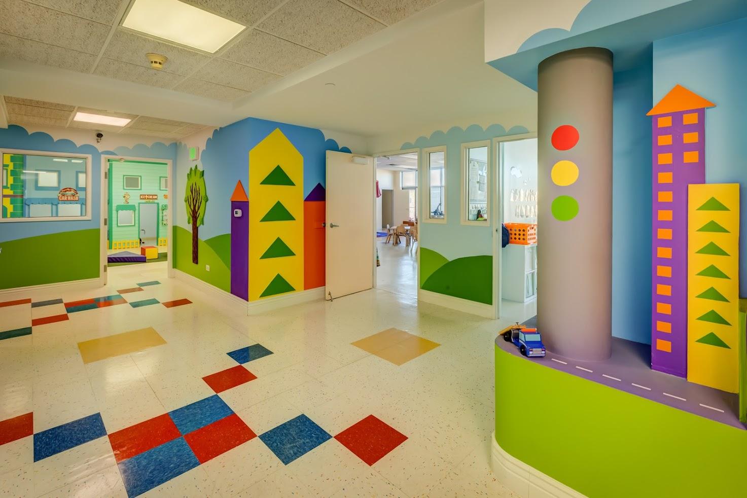 A hallway with colorful tiles and buildings painted on the walls