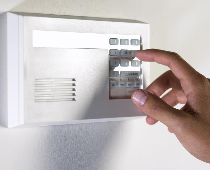 Hand Pressing Home Alarm Buttons — Rocklin, CA — Foothill Alarm Systems