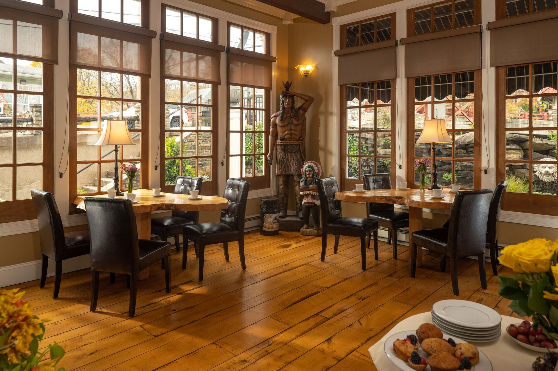 A bedroom with a sleigh bed and a table with food on it