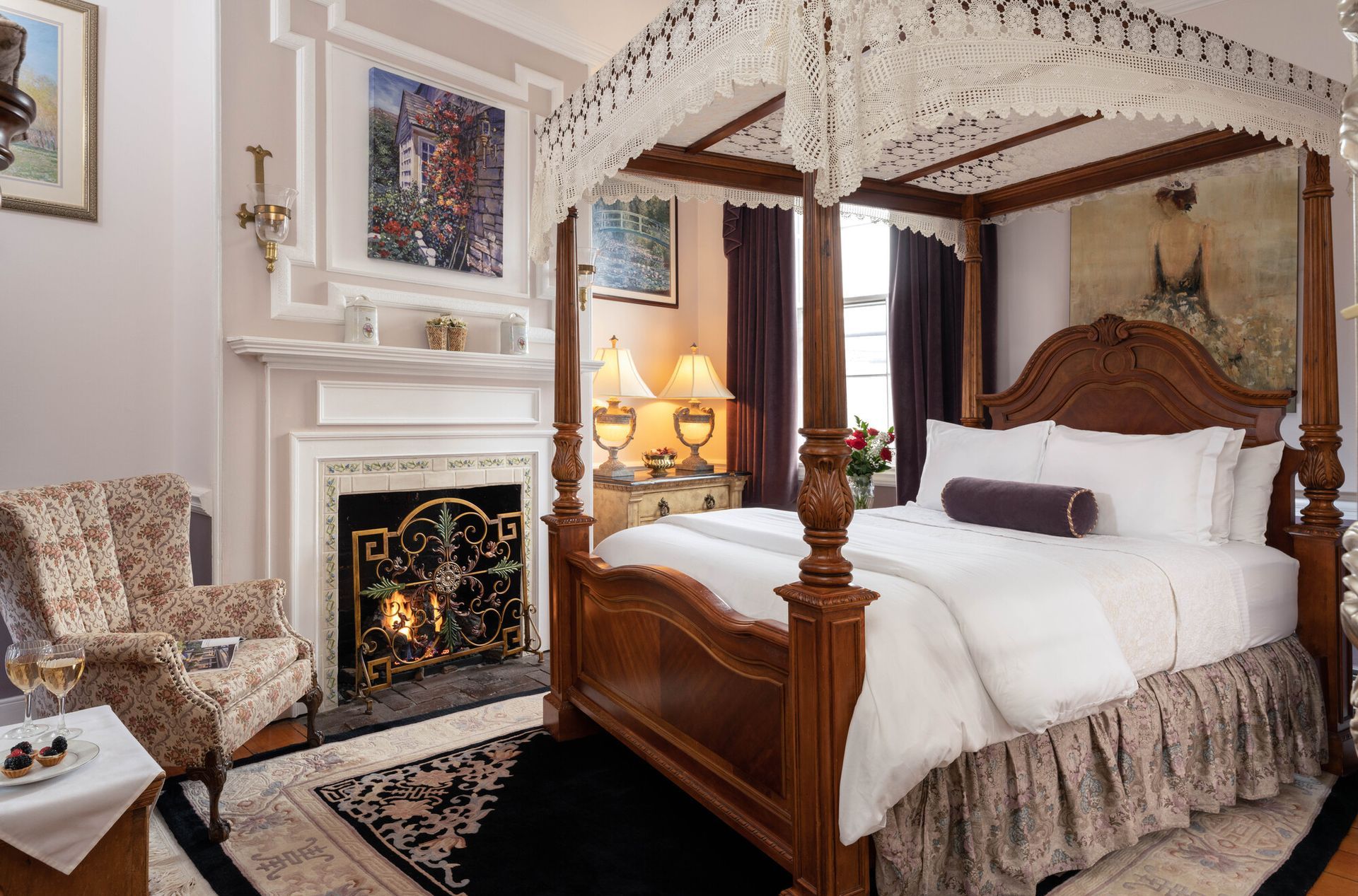 A bedroom with a sleigh bed and a table with food on it