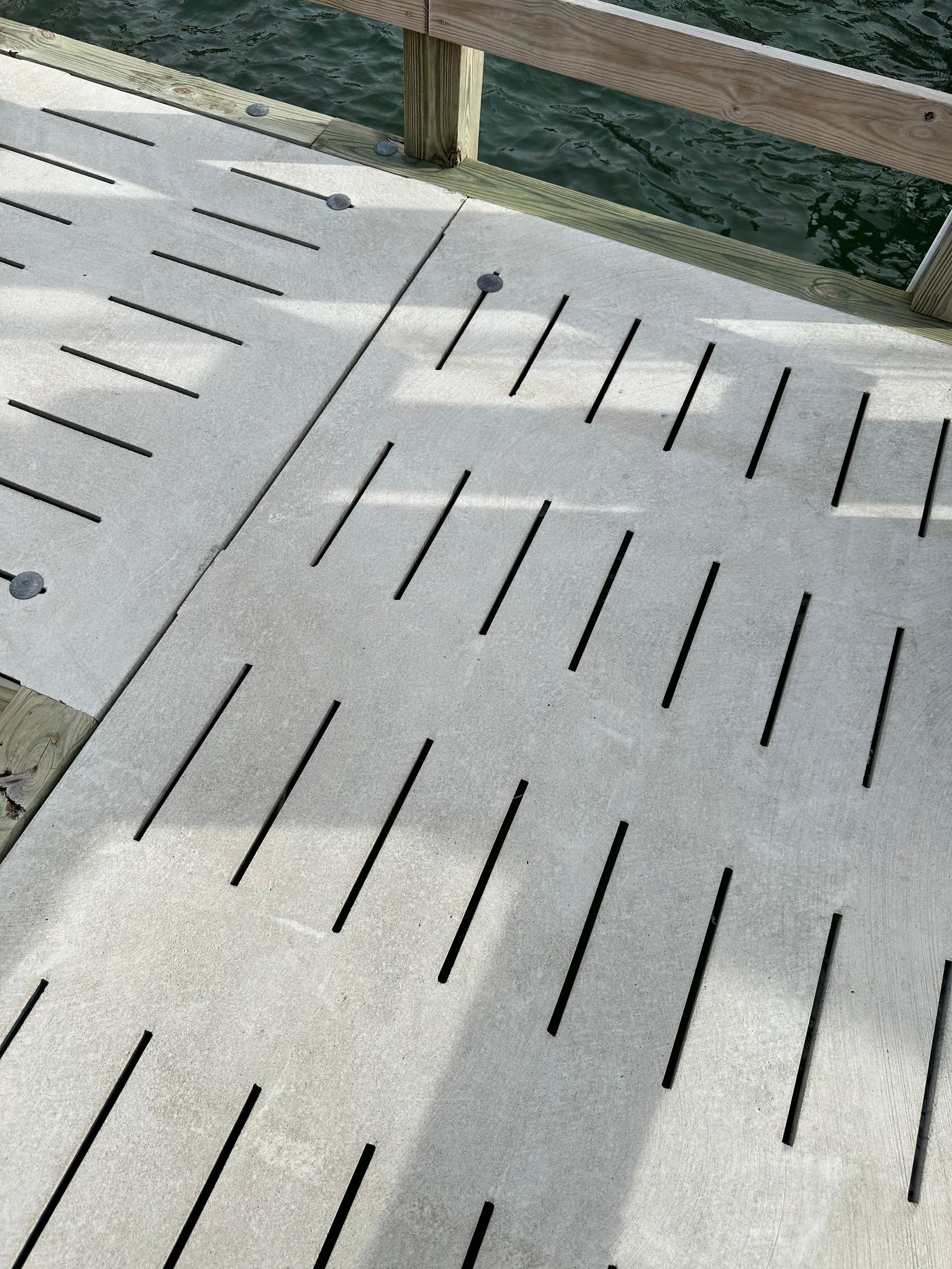 Close-up of a pier deck with many evenly spaced, long slots.