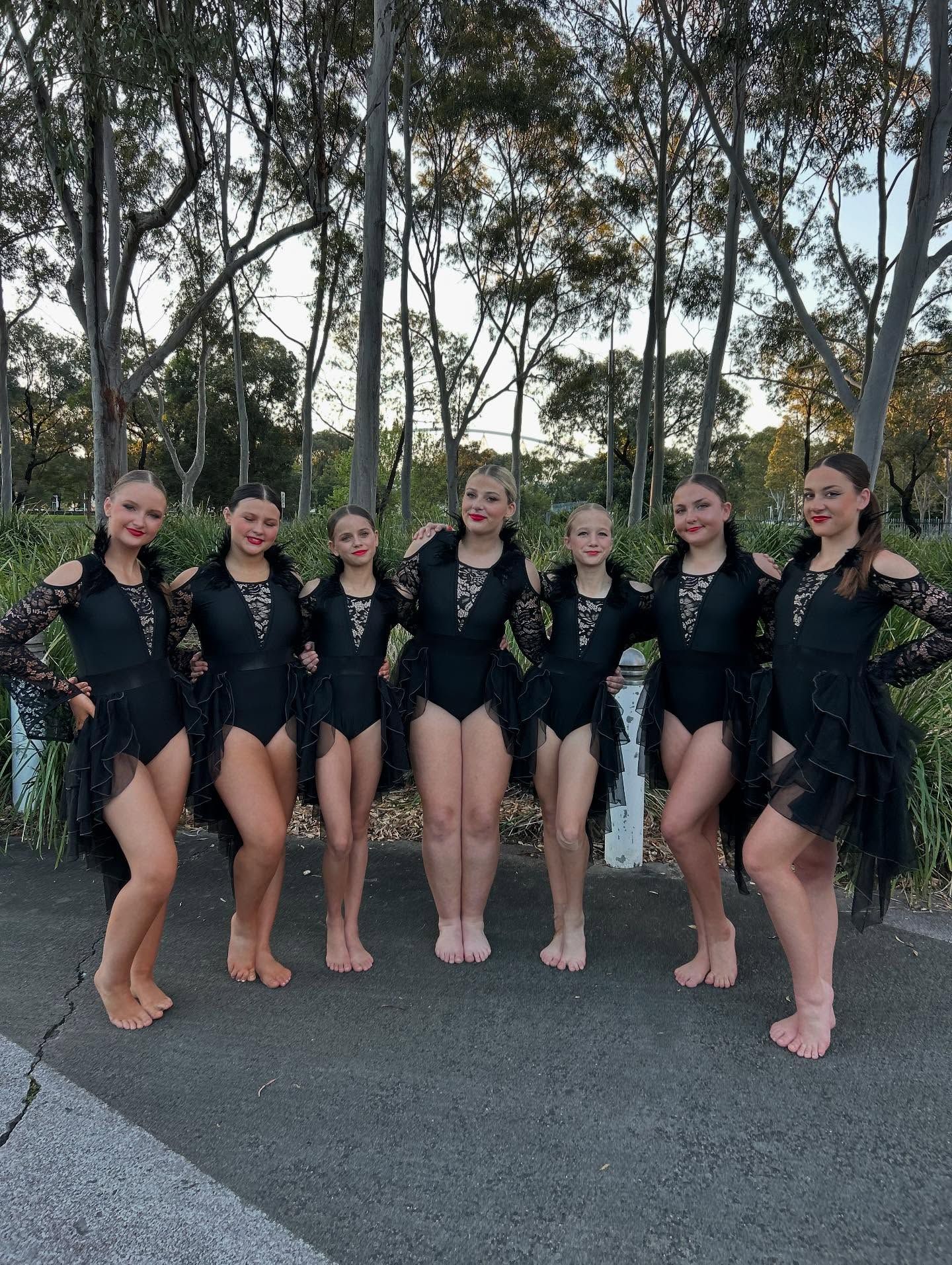 Dancers in Black Leotards and Skirts Pose Outdoors — iDance Performance Co In Medowie, NSW