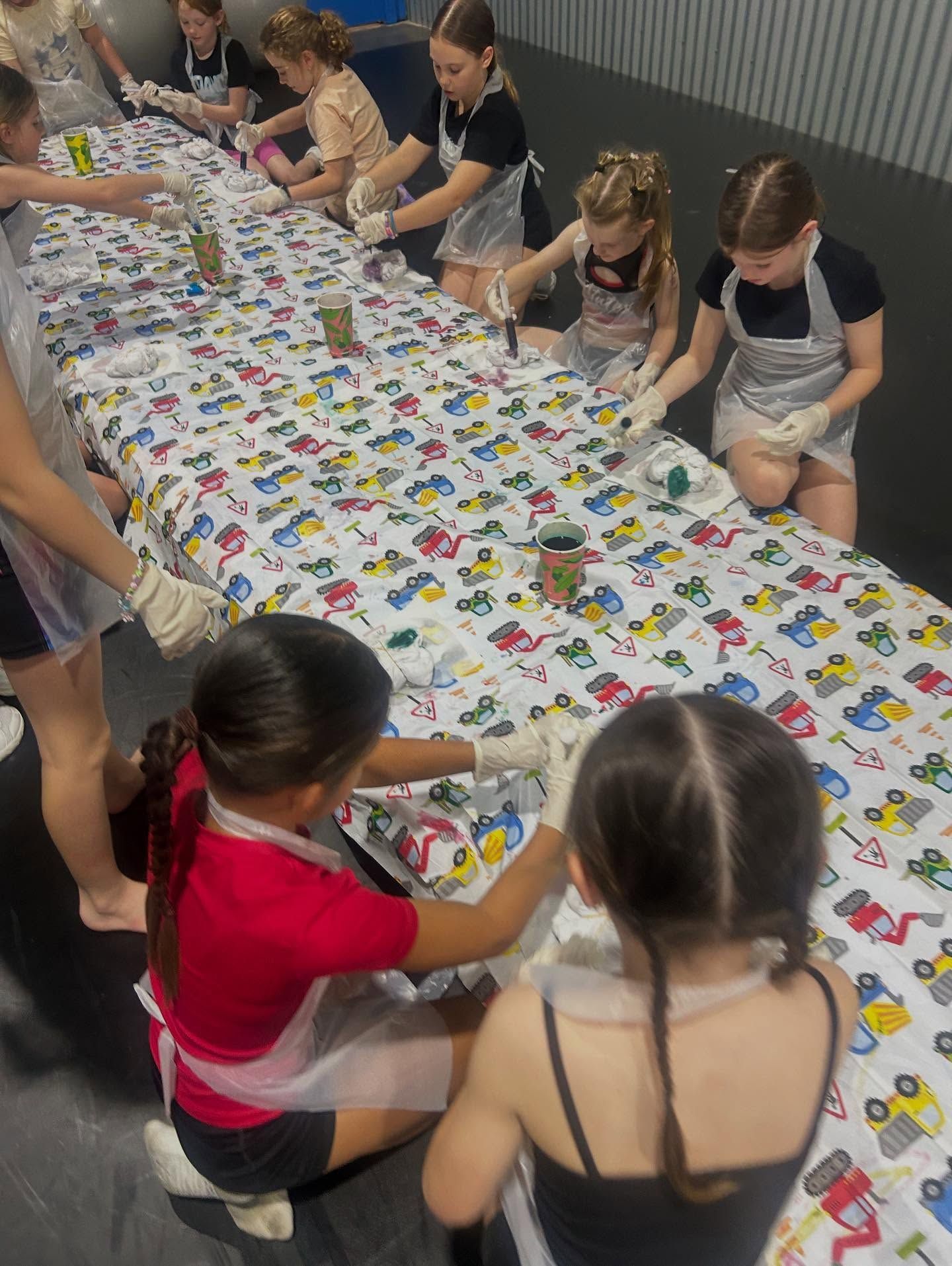 Children in Aprons and Gloves Tie-dyeing on a Long Table Covered — iDance Performance Co In Medowie, NSW