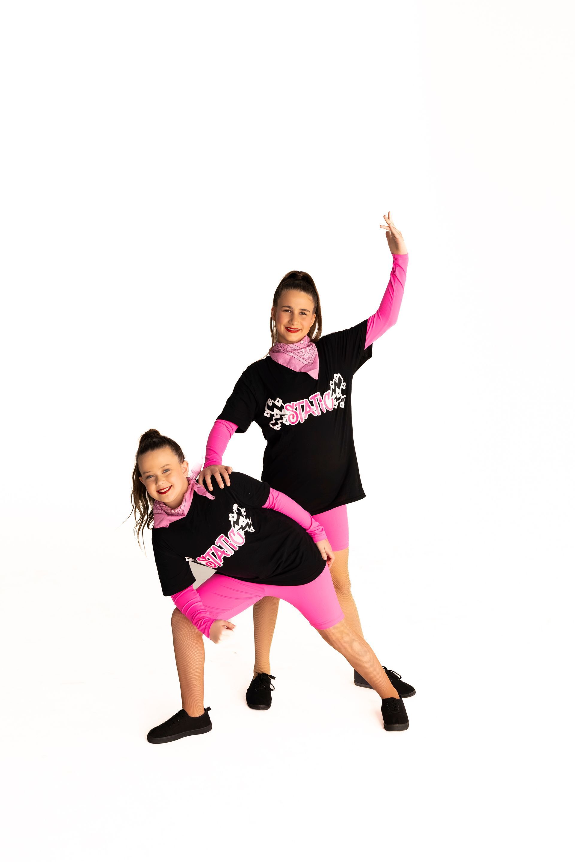 Two People in Black Shirts and Shorts, Jumping With Arms Raised — iDance Performance Co In Medowie, NSW