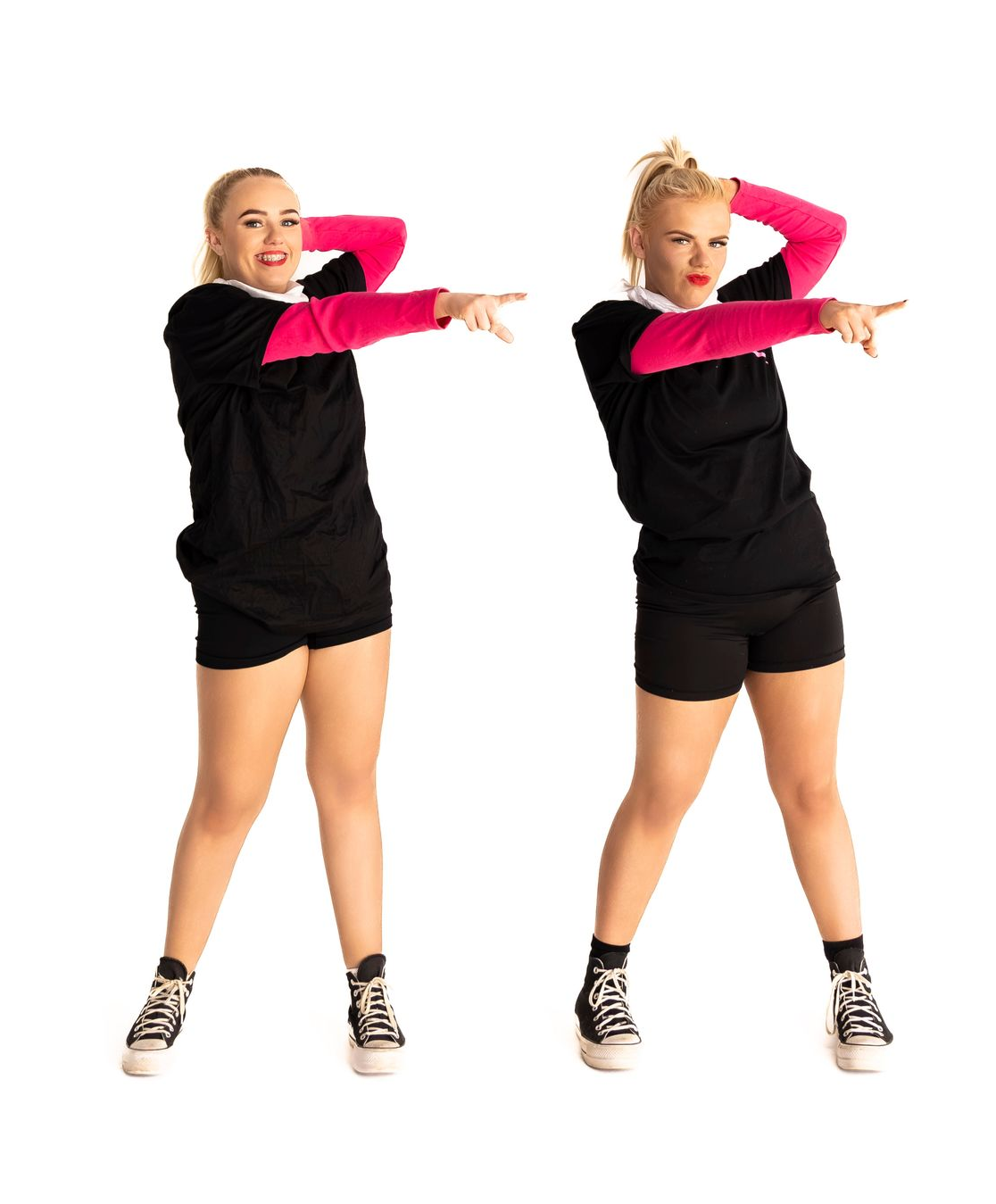 Two people in black shirts and shorts, pink sleeves, sneakers, pointing, one smiling — iDance Performance Co In Medowie, NSW