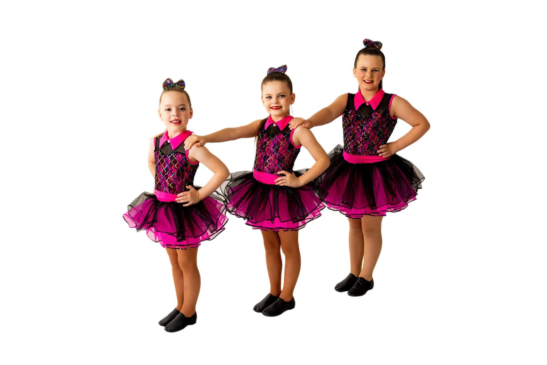 Three dancers in pink and black costumes pose, smiling — iDance Performance Co In Medowie, NSW
