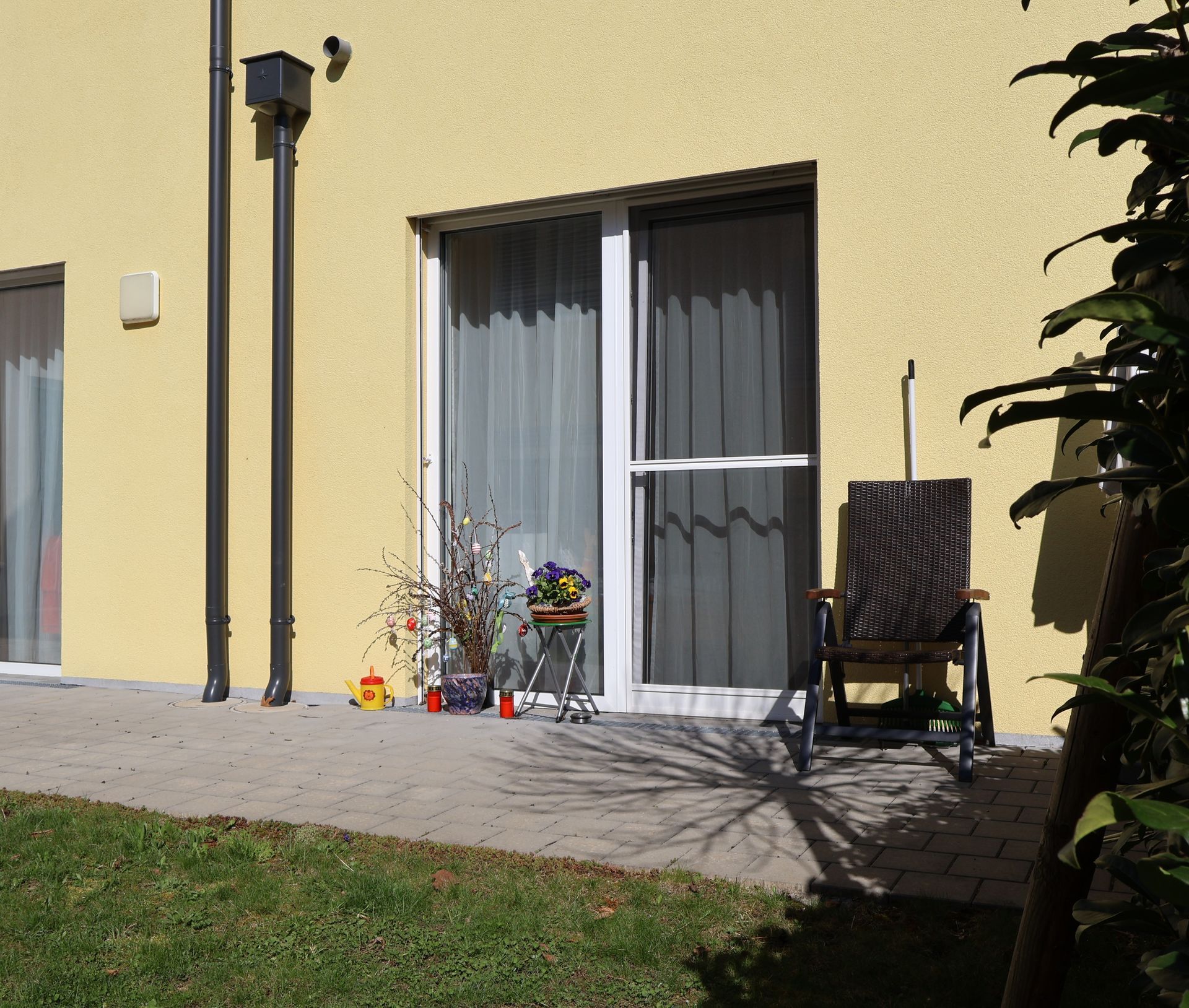 Ein gelbes Haus mit einer Glasschiebetür