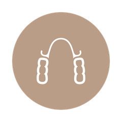 A line drawing of a denture in a brown circle.