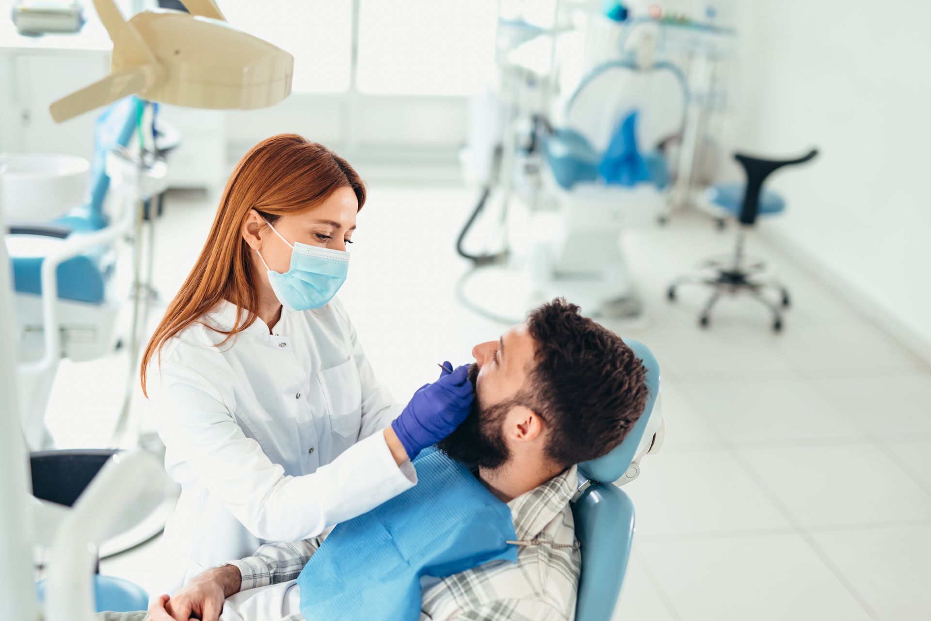 A dentist is examining a patient's teeth in a dental office. A dentist is examining a patient's teeth in a dental office.