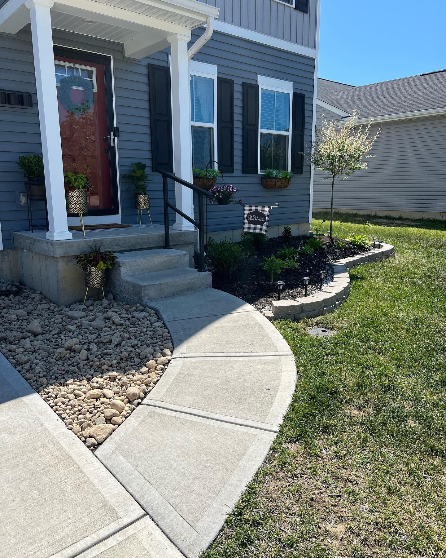 A house with a concrete walkway leading to the front door