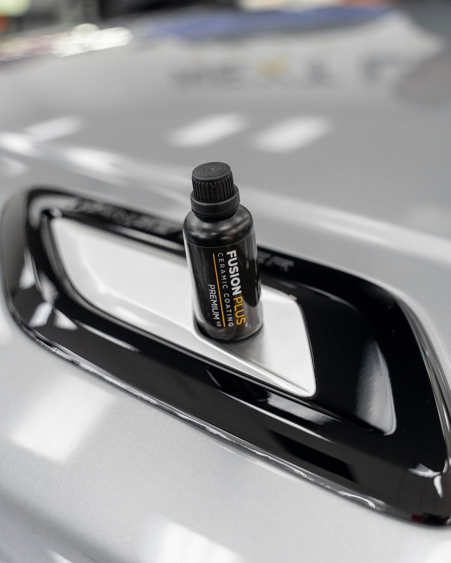 ceramic coating bottle on top of the car