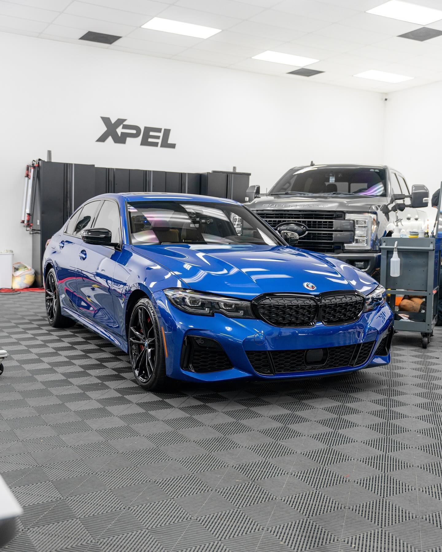 blue vehicle with ceramic coating parked inside the shop