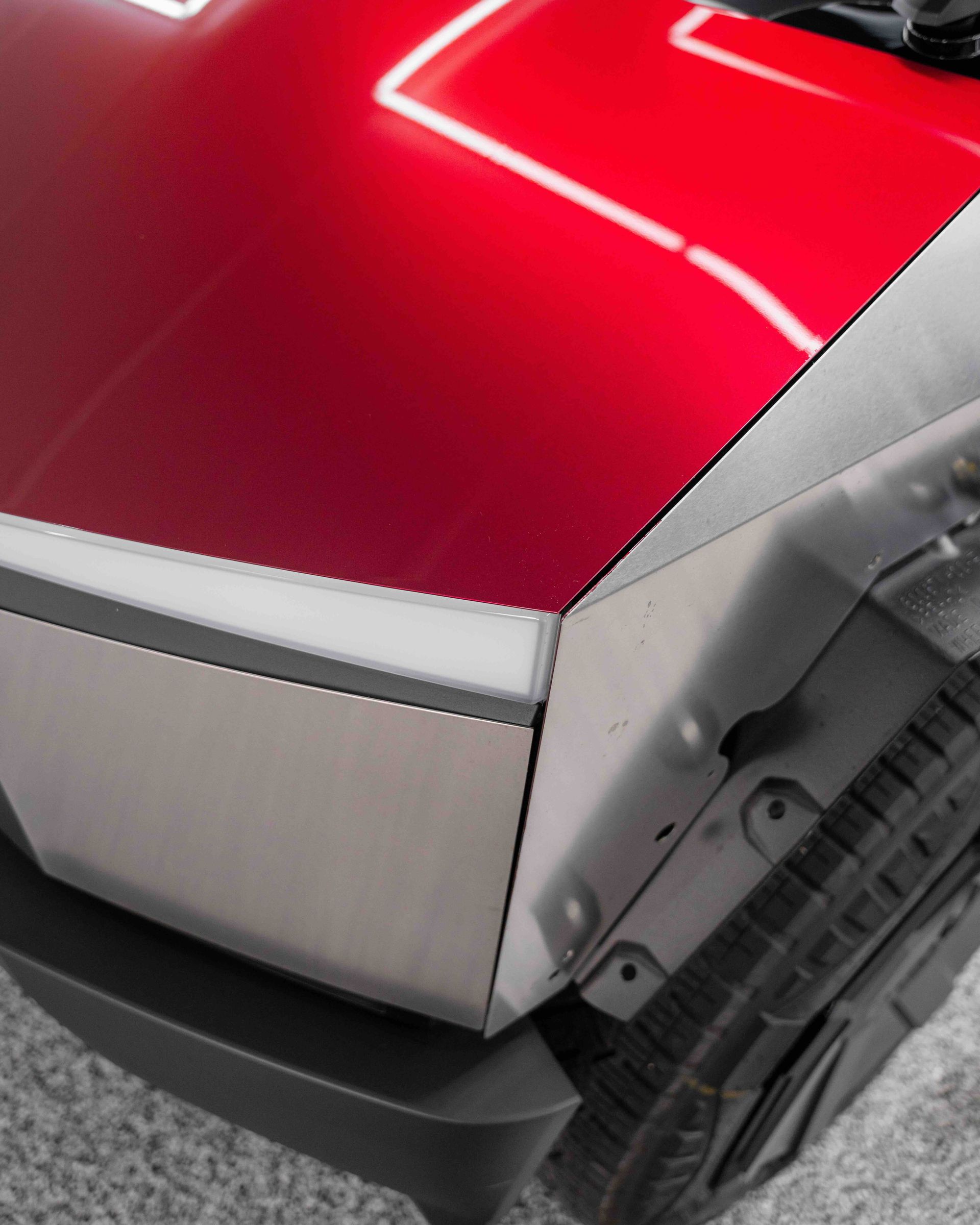 A close up of a red car with a black tire