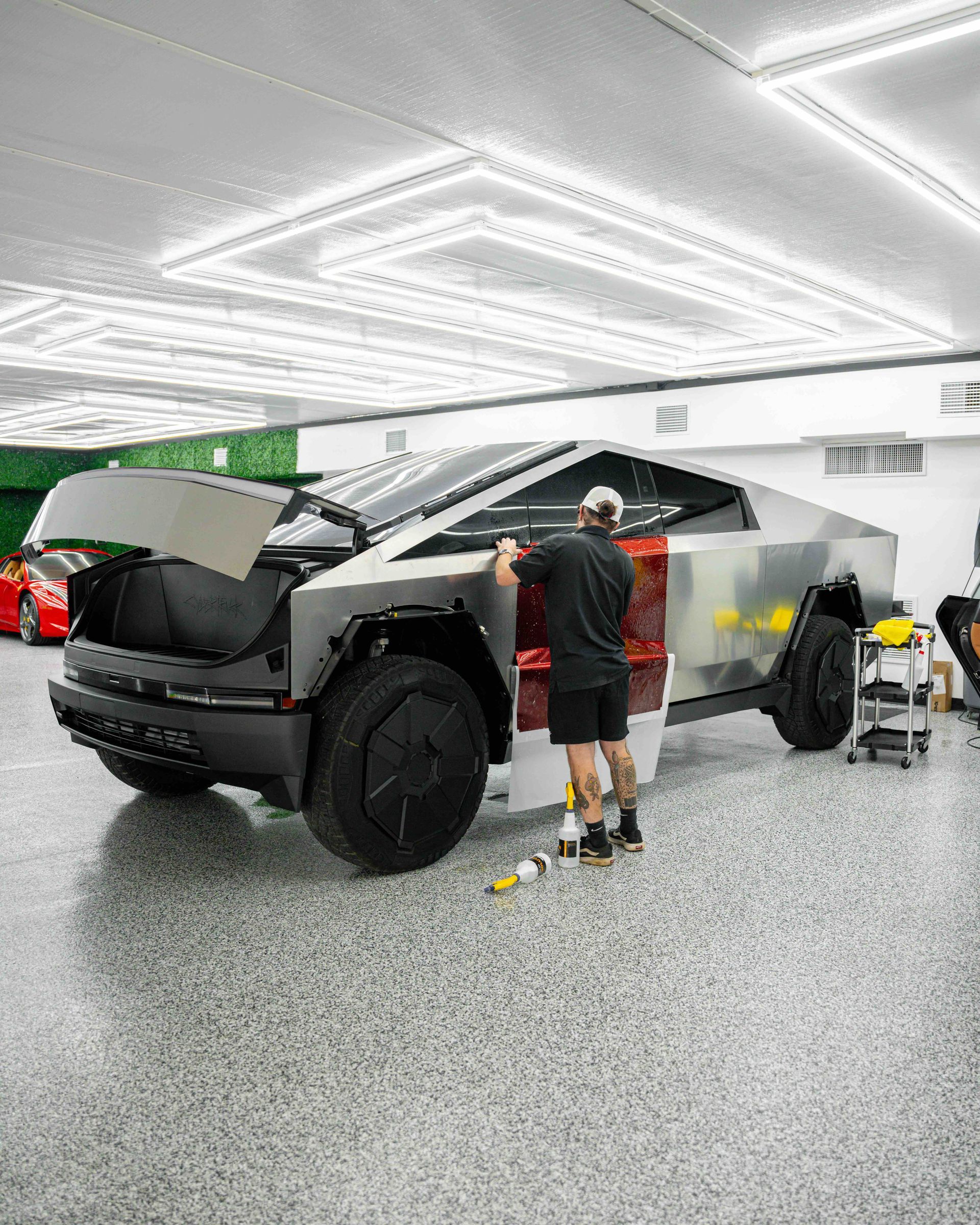 A man is working on a car in a garage.