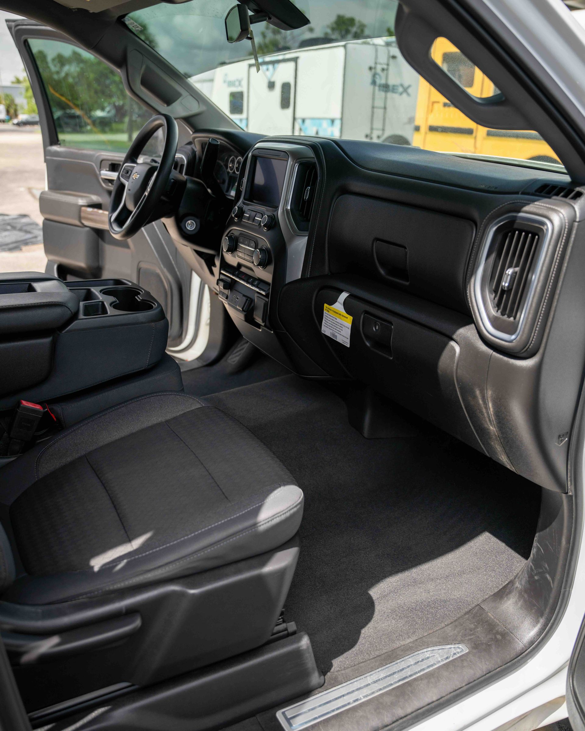 The interior of a silver truck with the door open