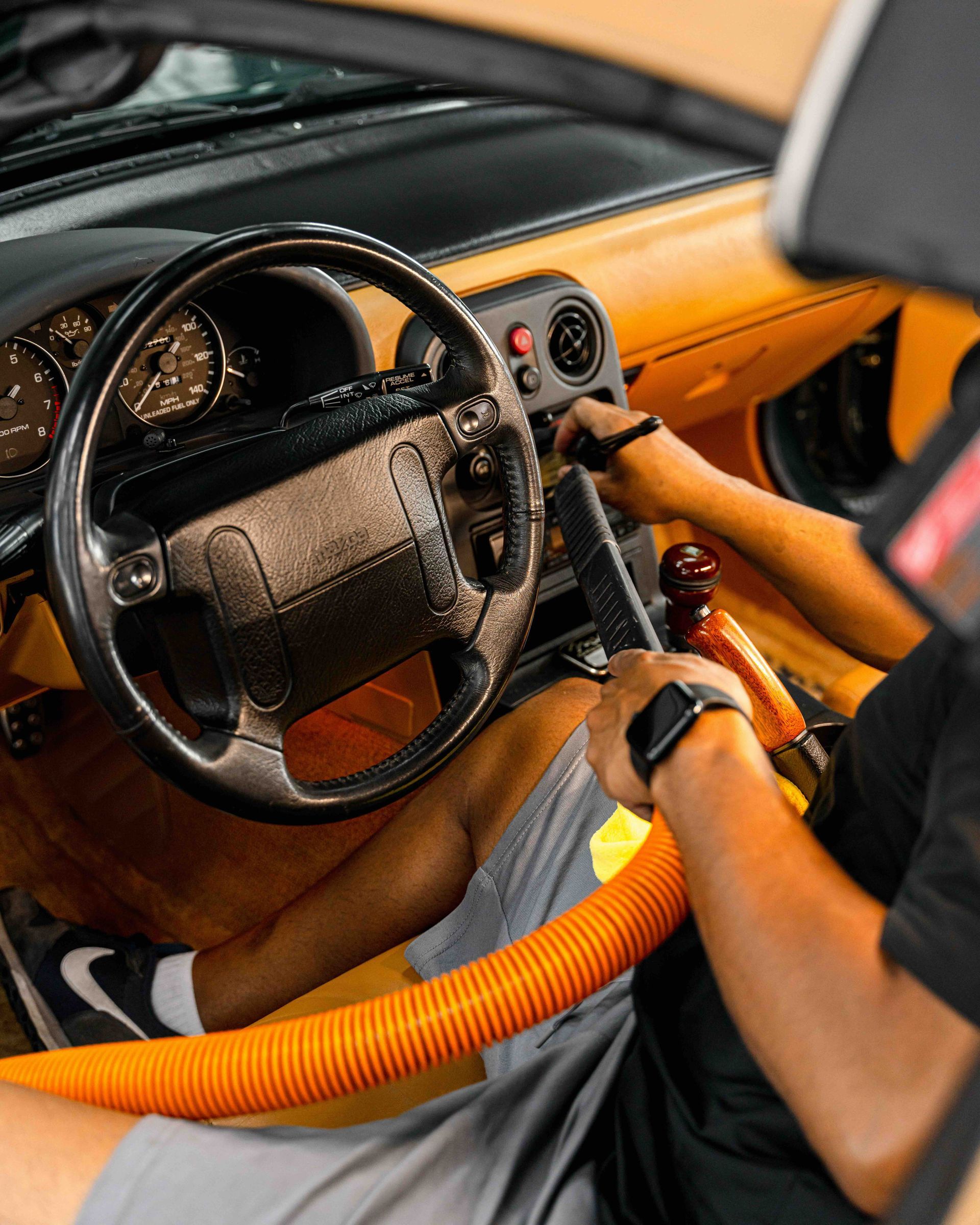A man is sitting in the driver 's seat of a car