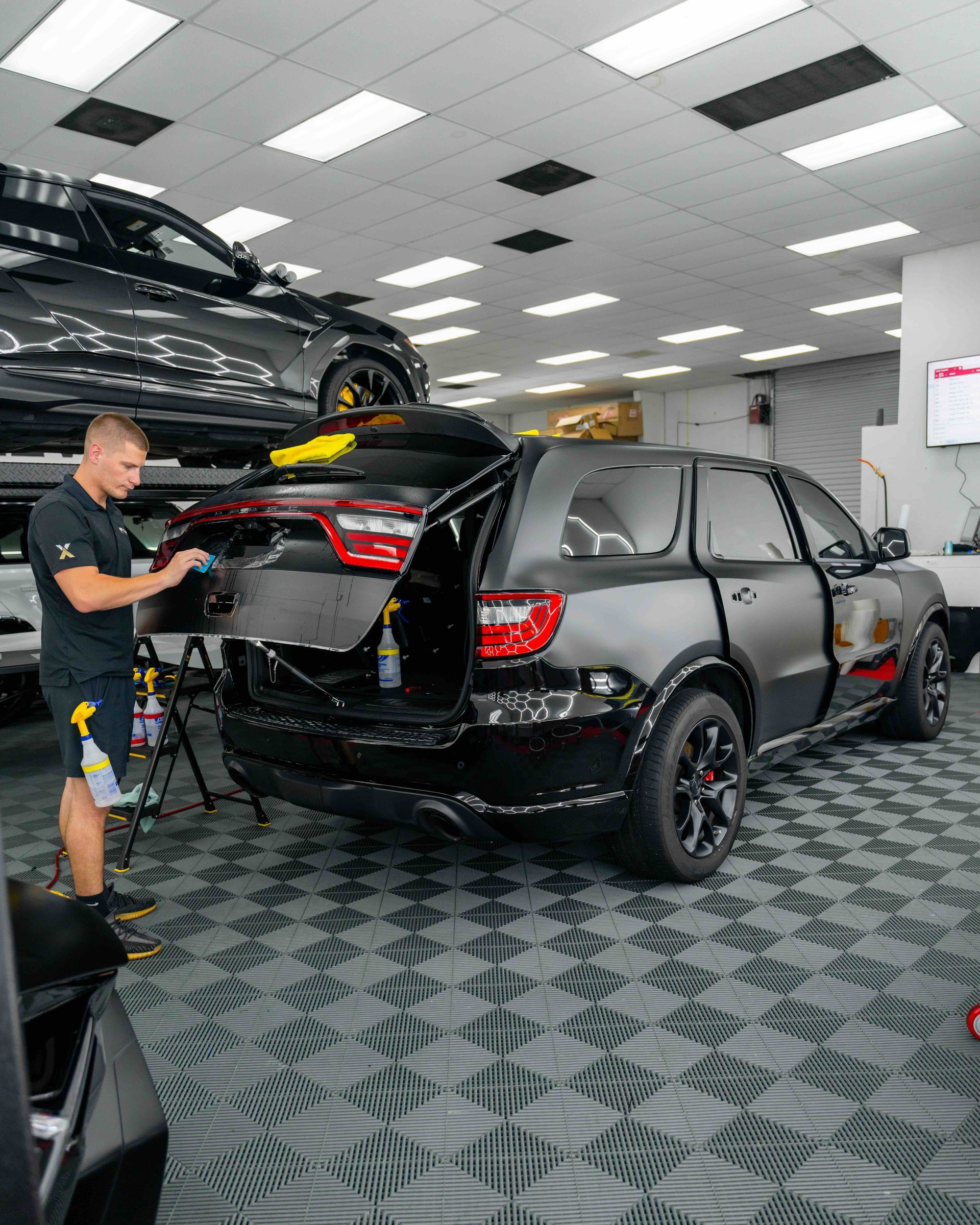 A man is working on a car in a garage.