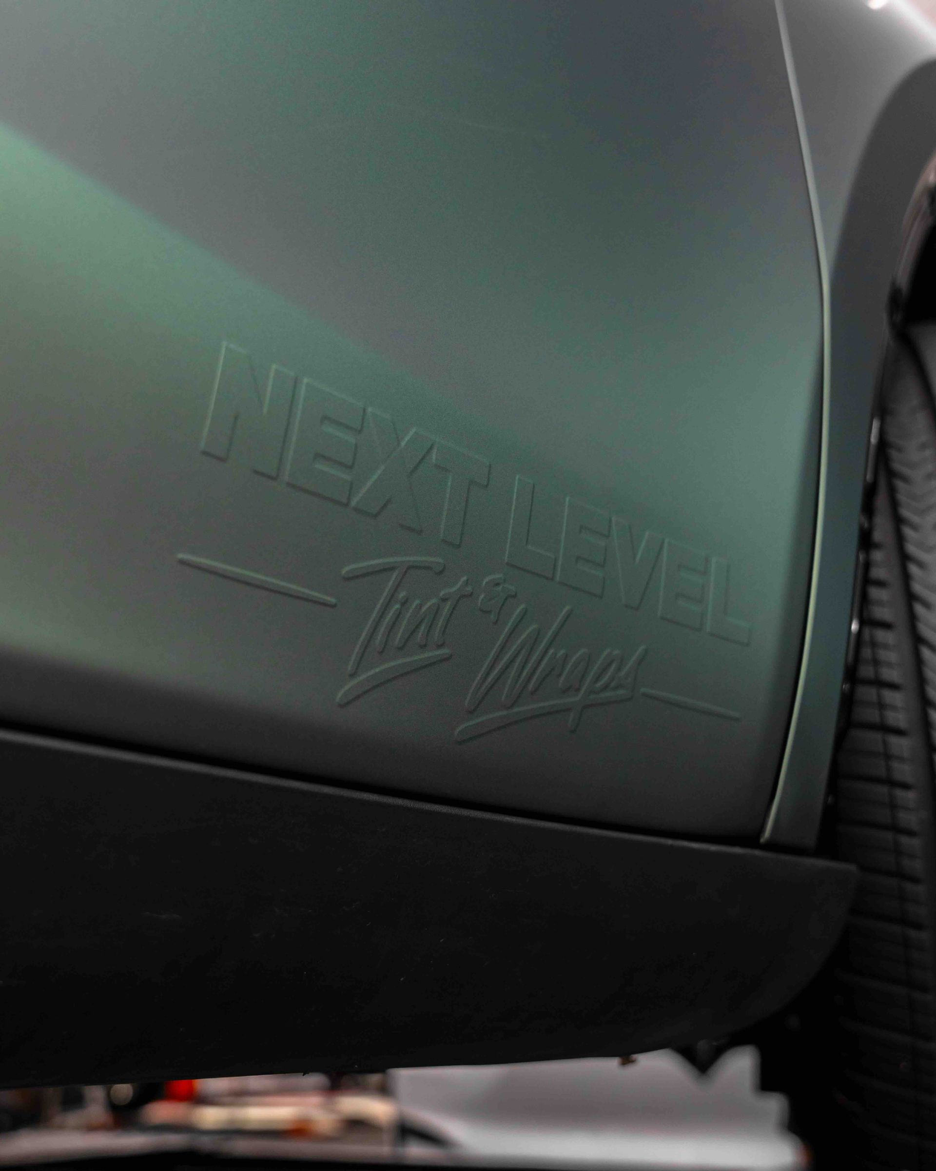 A close up of a green car 's headlight