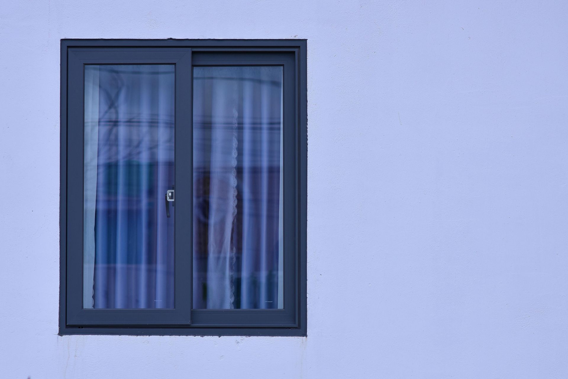 A building with a reflection of trees in the windows