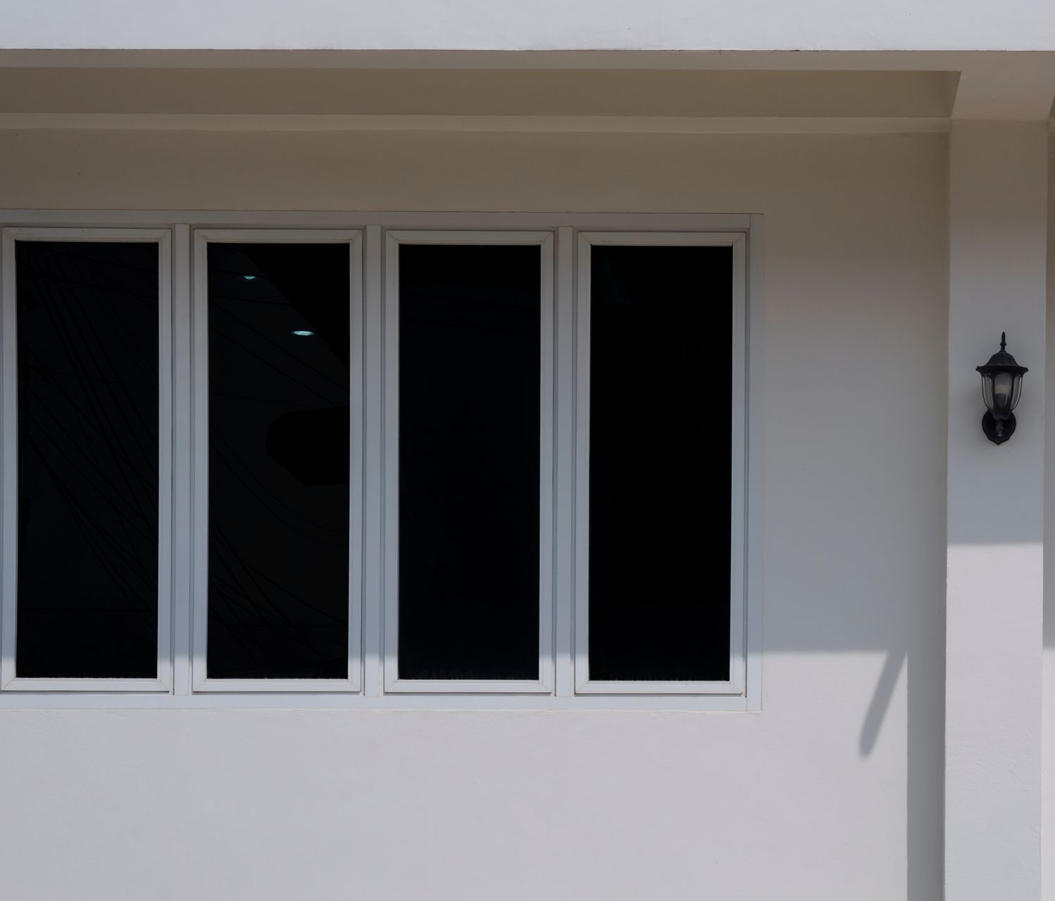 A balcony with sliding glass doors and a metal railing