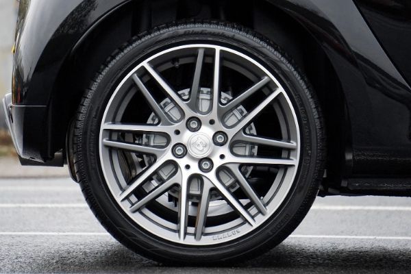 A close up of a car wheel with a tire on it