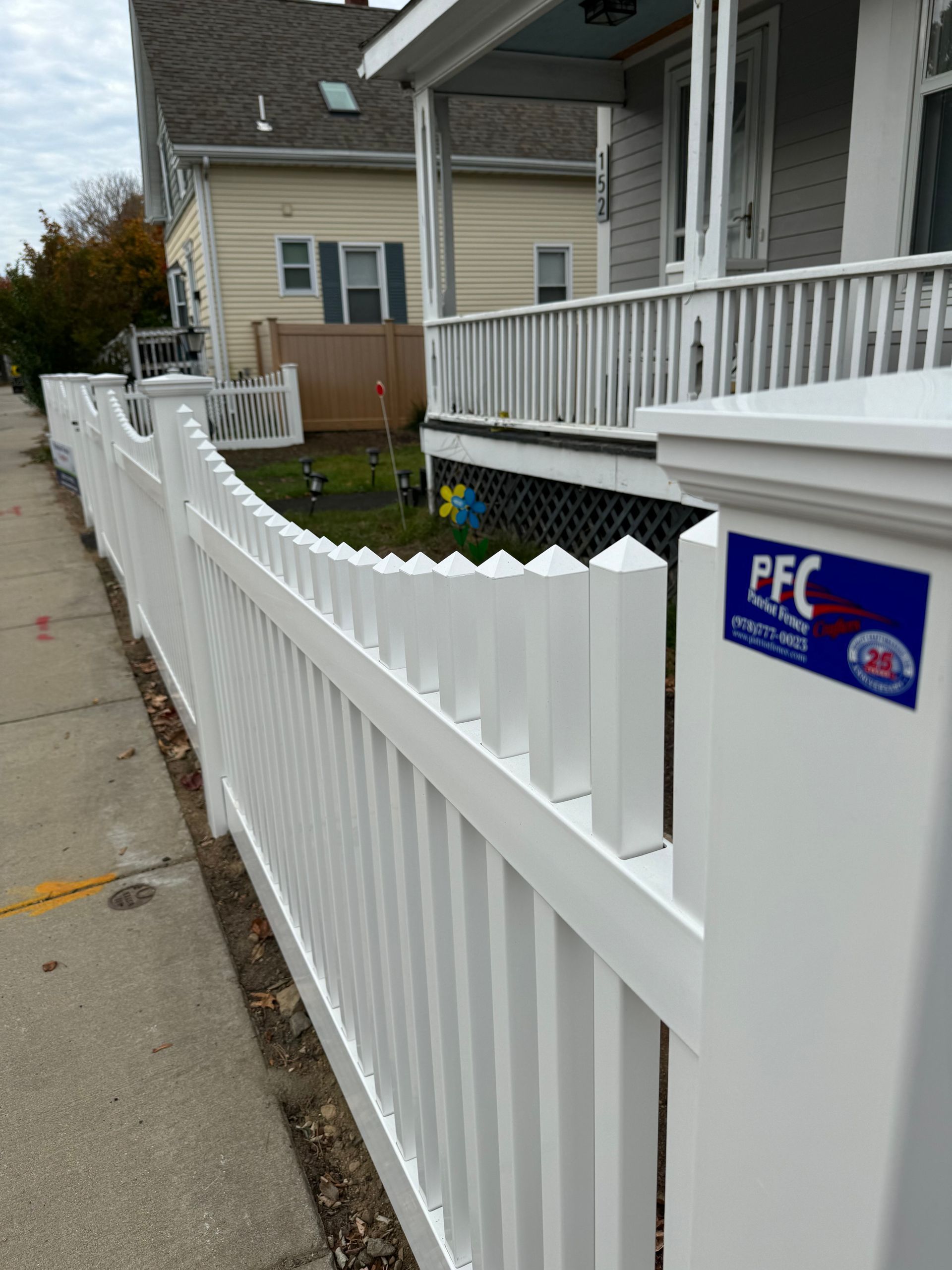 A white fence with a pfc sticker on it