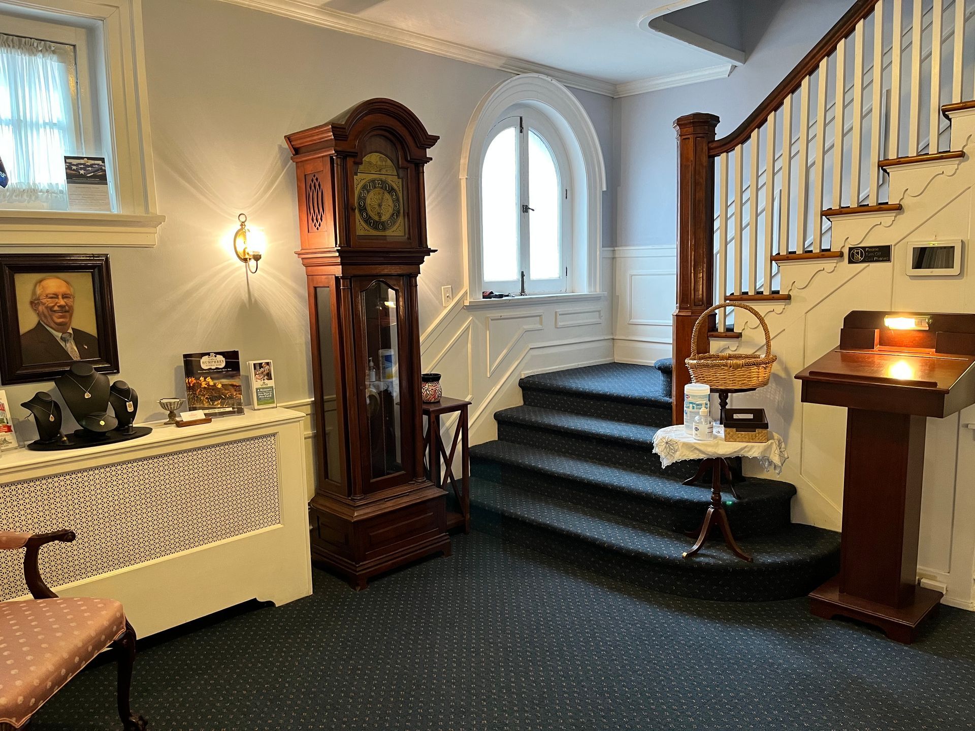 a room with stairs and a large clock