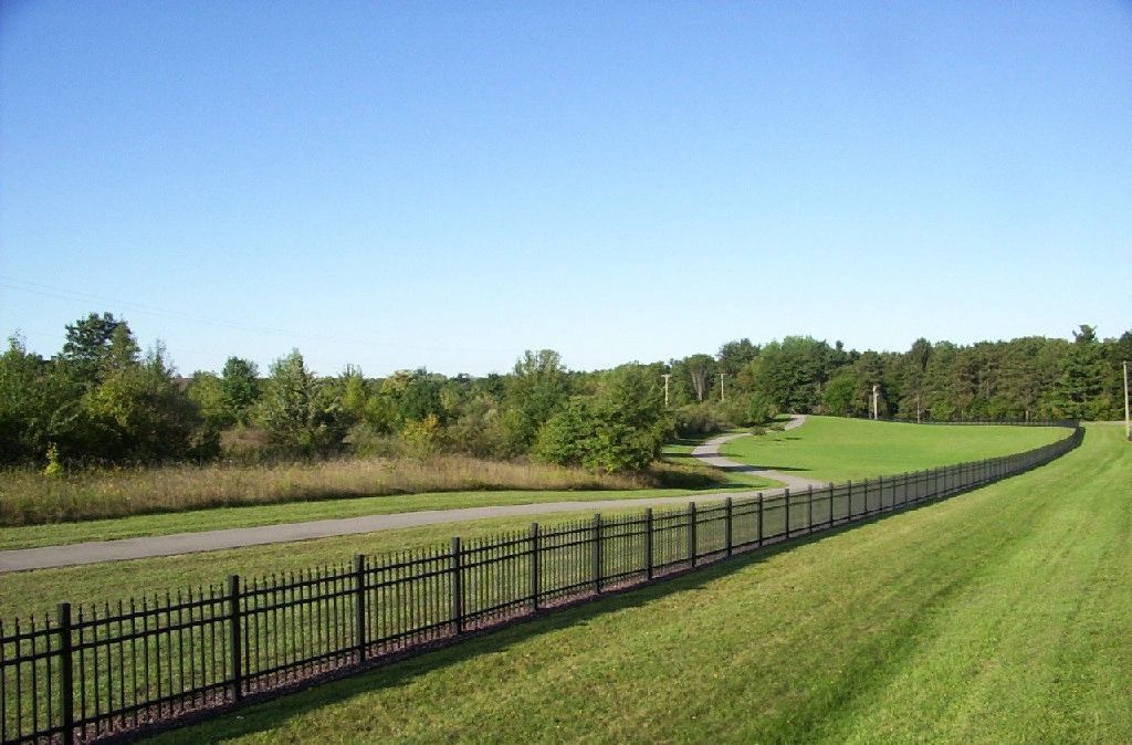 Asphalt Road and Long Steel Fence — Battle Creek, MI — Damron Brother’s Asphalt
