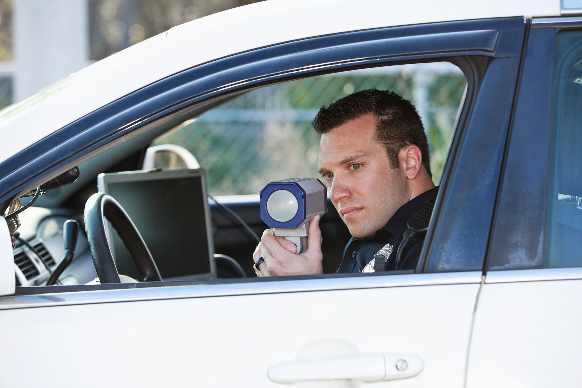 A person is driving a car and using a navigation system.