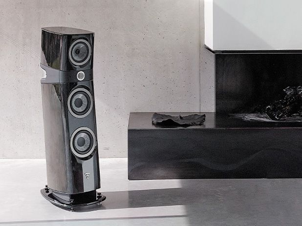 A pair of speakers sitting next to a fireplace in a living room.