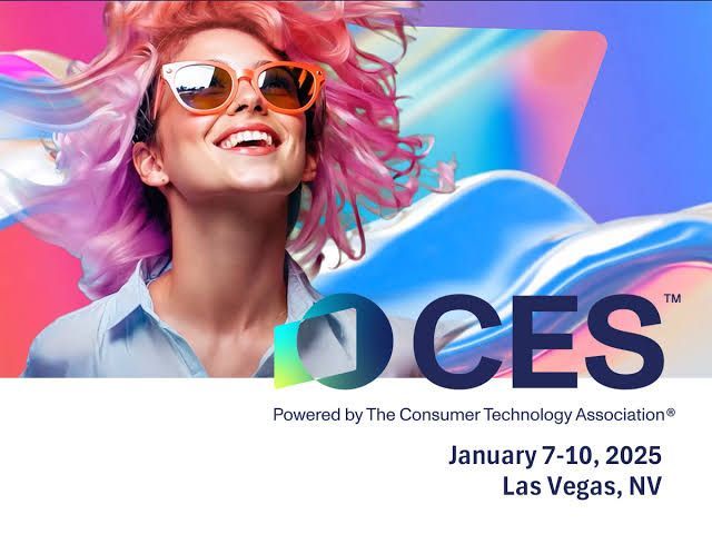 A woman with pink hair is smiling in front of a CES logo