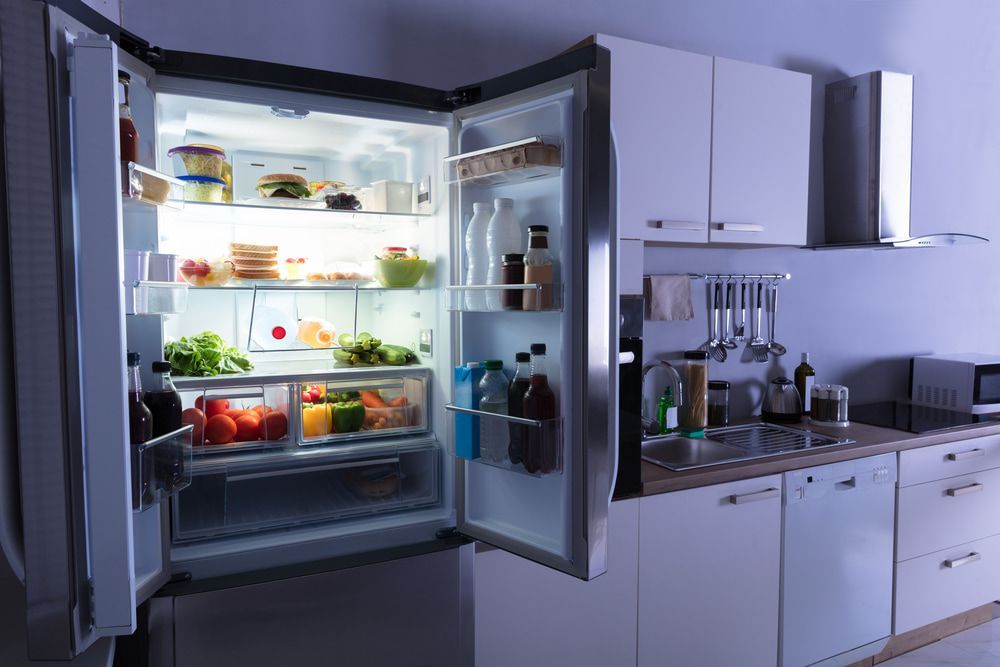 Open Refrigerator Full Of Foods And Drinks In The Kitchen — Oriel Refrigeration and Air Conditioning in Nyngan, NSW