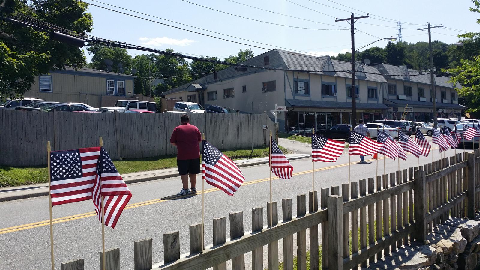 Fence with US Flags Near Road — Mahopac, NY — Mahopac Marina