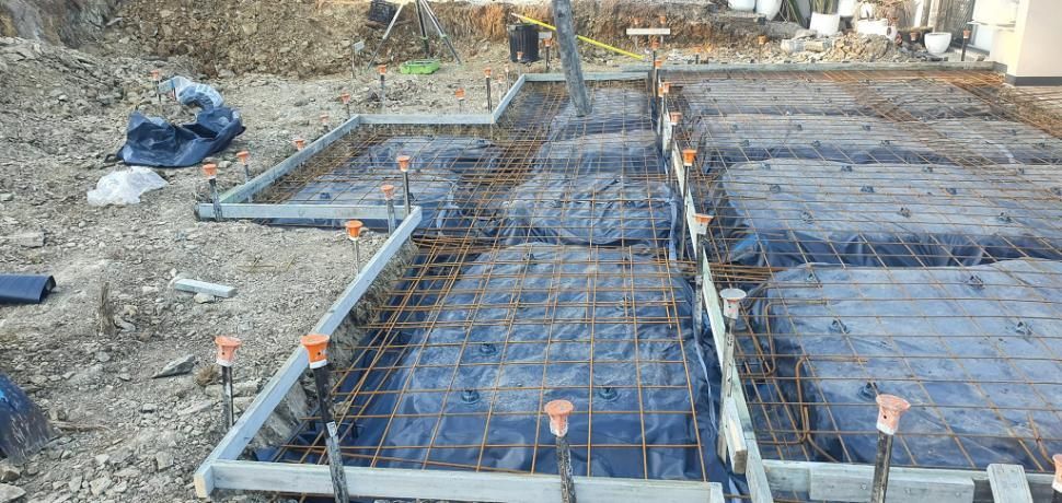A Concrete Base for A House Is Being Built on A Dirt Fiel — Kontek Constructions in Brisbane, QLD