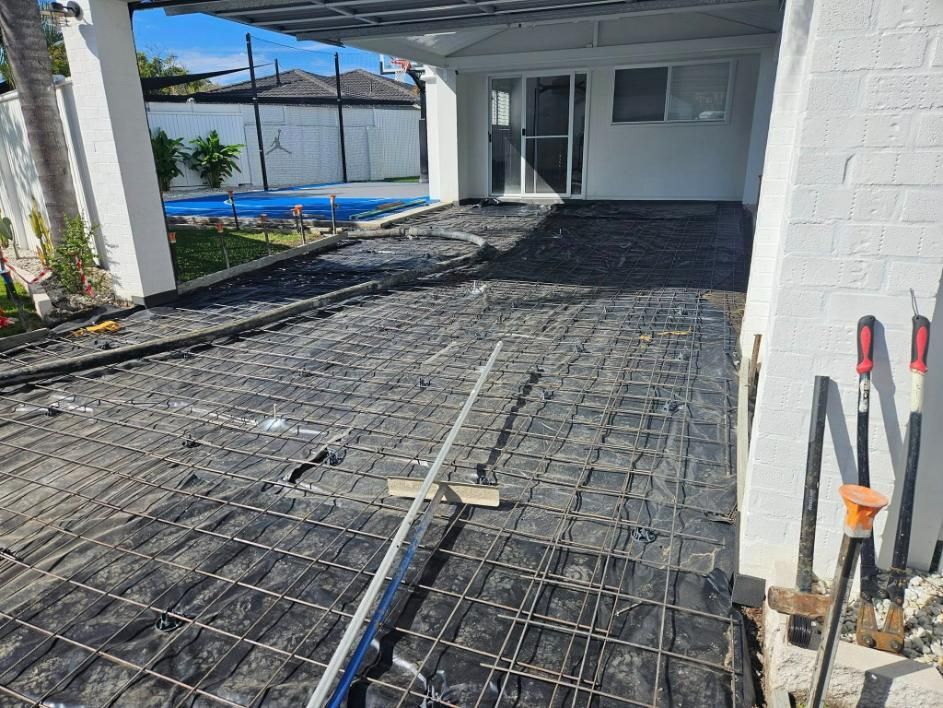 A Concrete Driveway Is Being Built in Front of A House — Kontek Constructions in Jimboomba, QLD