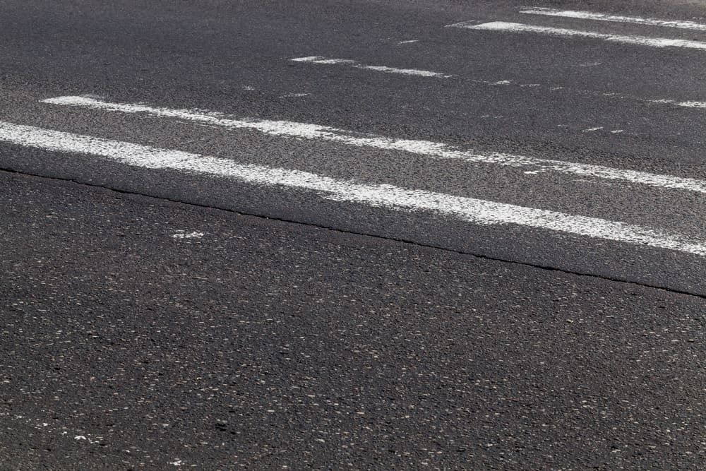 A Close Up of a Road With White Lines on It — Kontek Constructions in Jimboomba, QLD