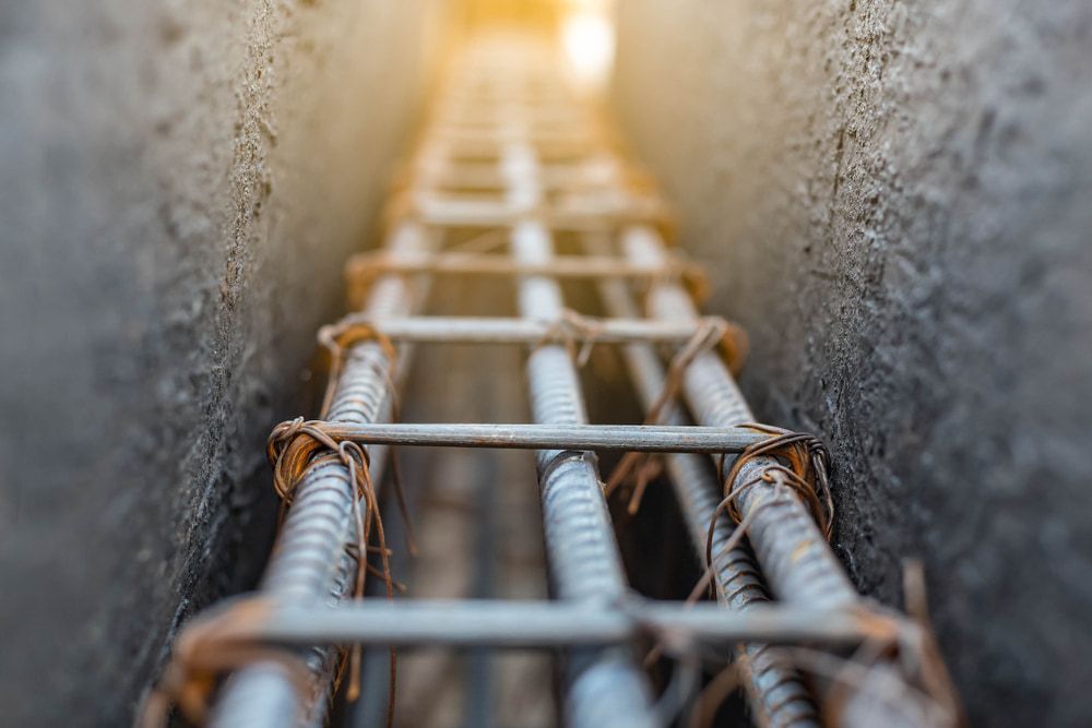 A Close Up of a Metal Bar in a Concrete Beam — Kontek Constructions in Jimboomba, QLD
