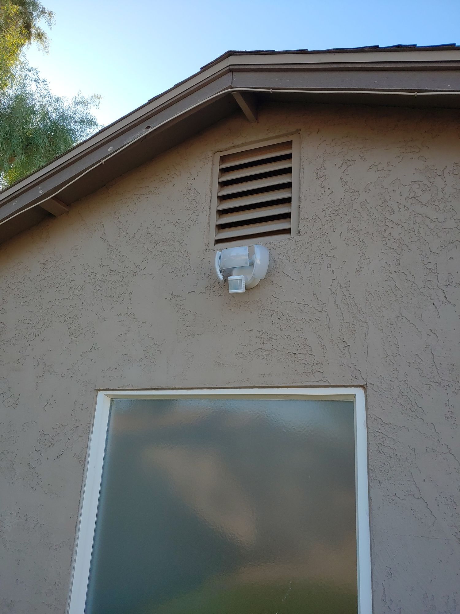 A house with a window and a light on the side