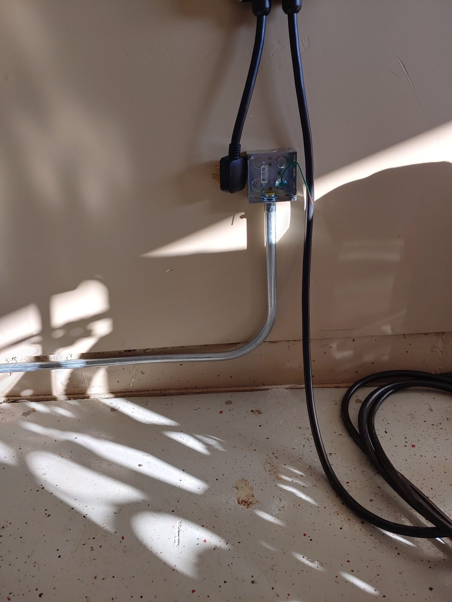 A power cord is plugged into a wall outlet