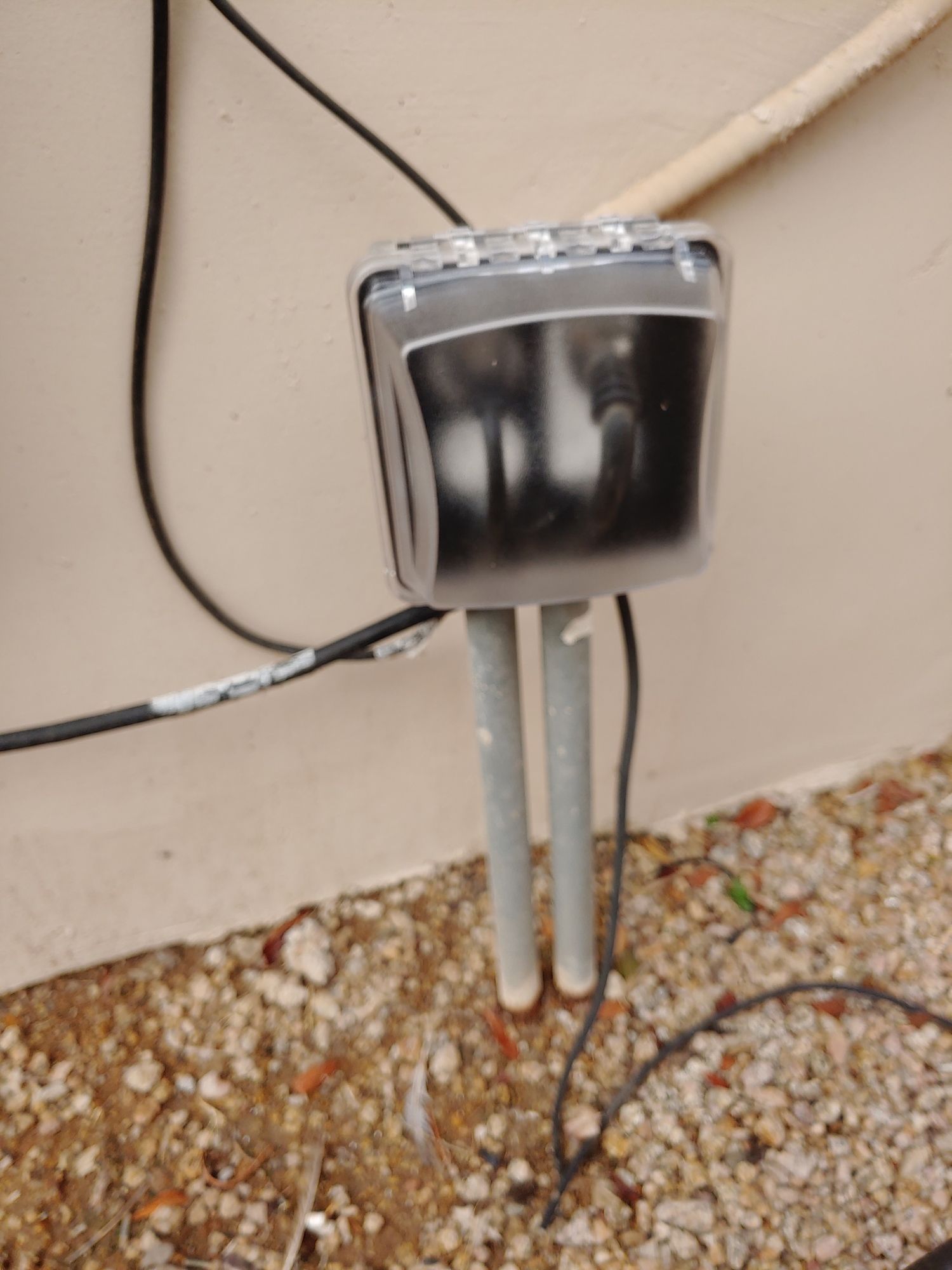 A box with wires coming out of it is sitting on the ground