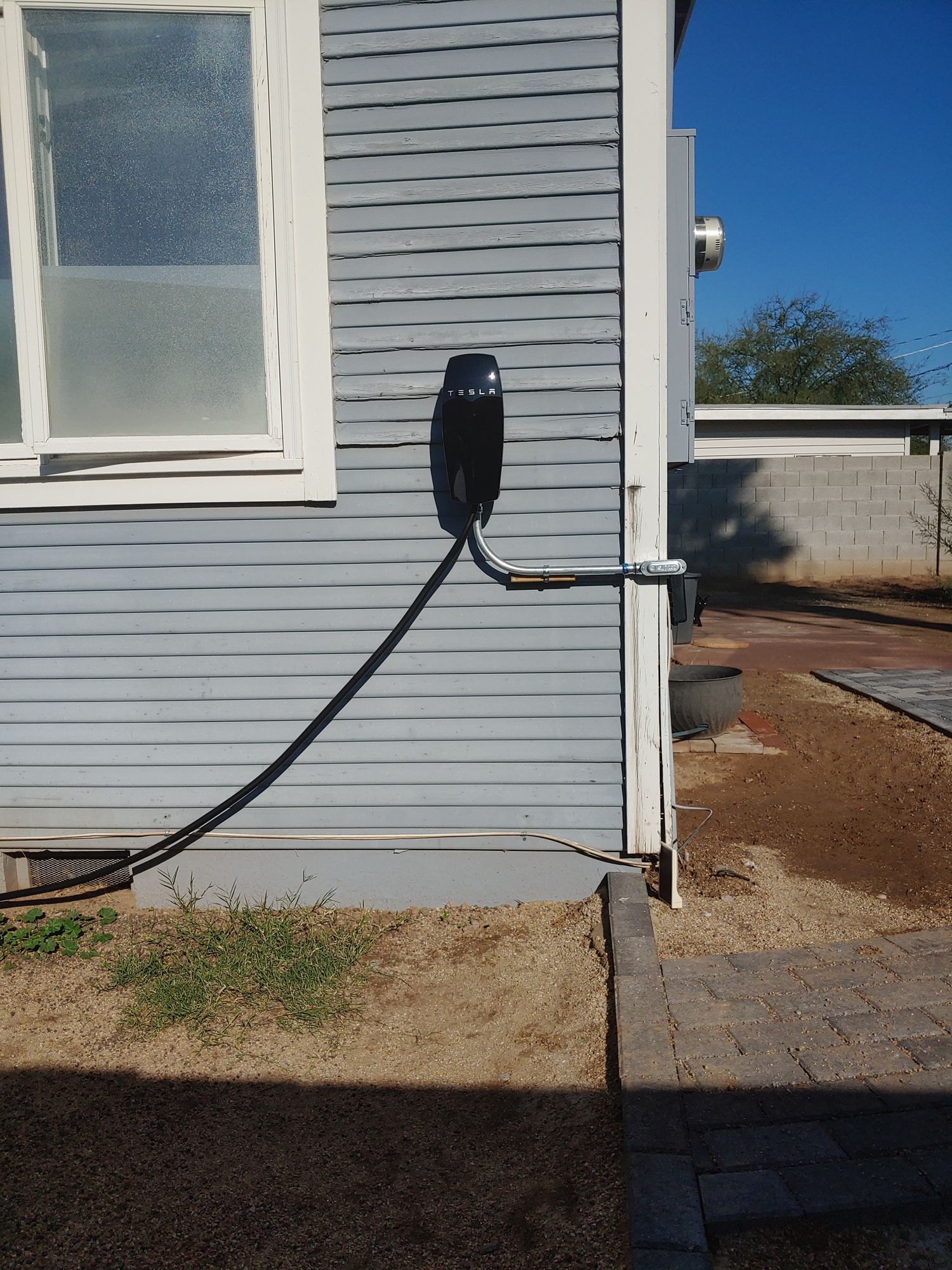 A telephone is plugged into the side of a house