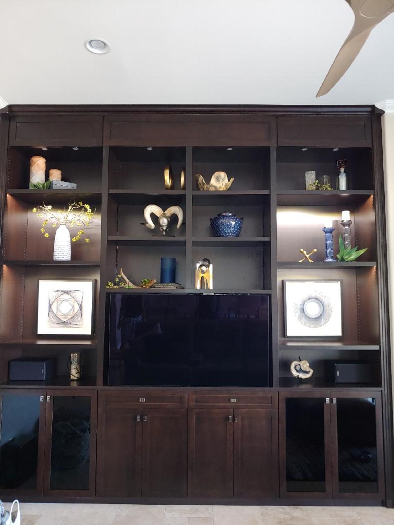 A large entertainment center with a flat screen tv