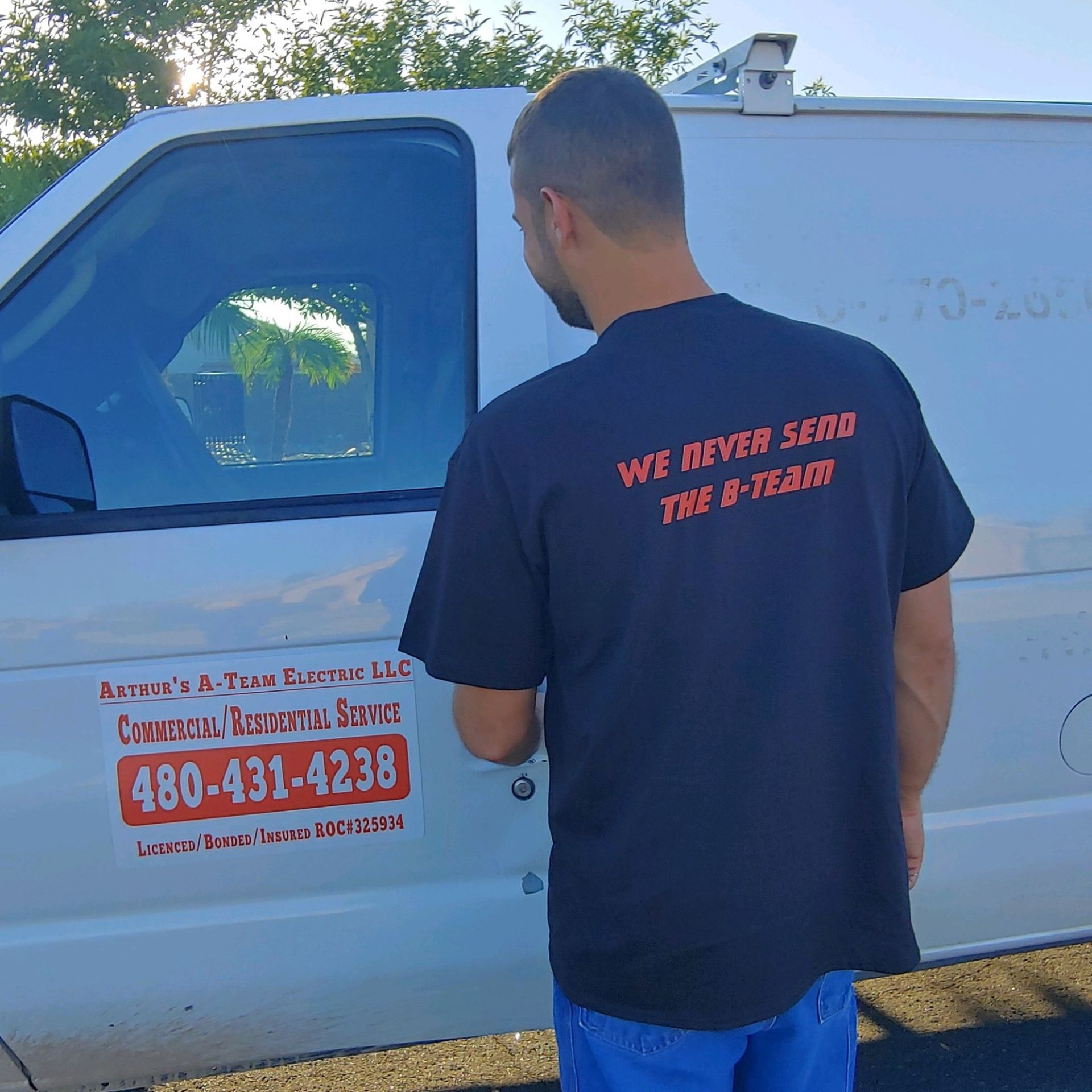 A man wearing a black shirt that says we never send the b-team