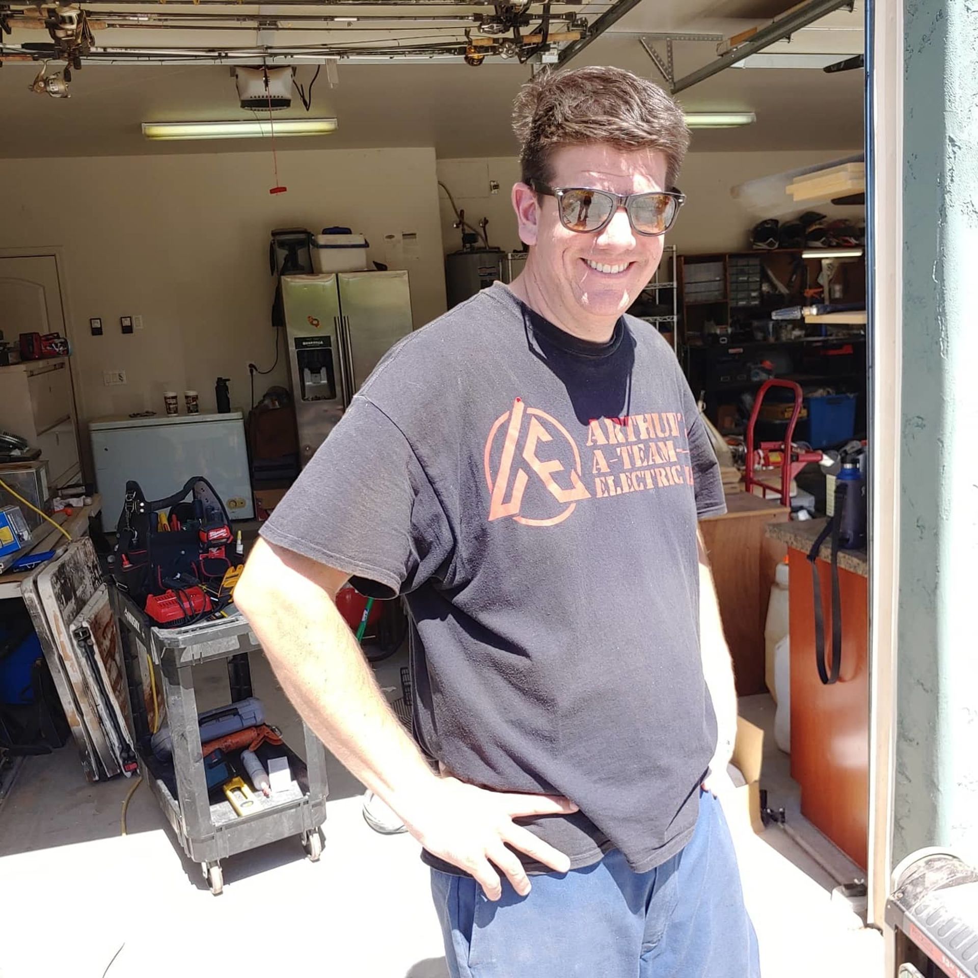 A man wearing sunglasses and a t-shirt that says altitude altitude altitude