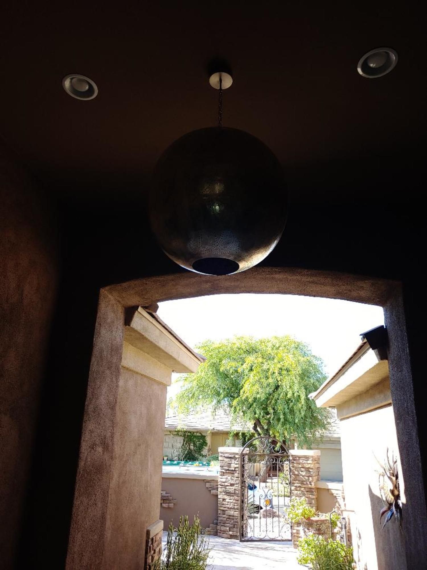 A large ball is hanging from the ceiling above a doorway