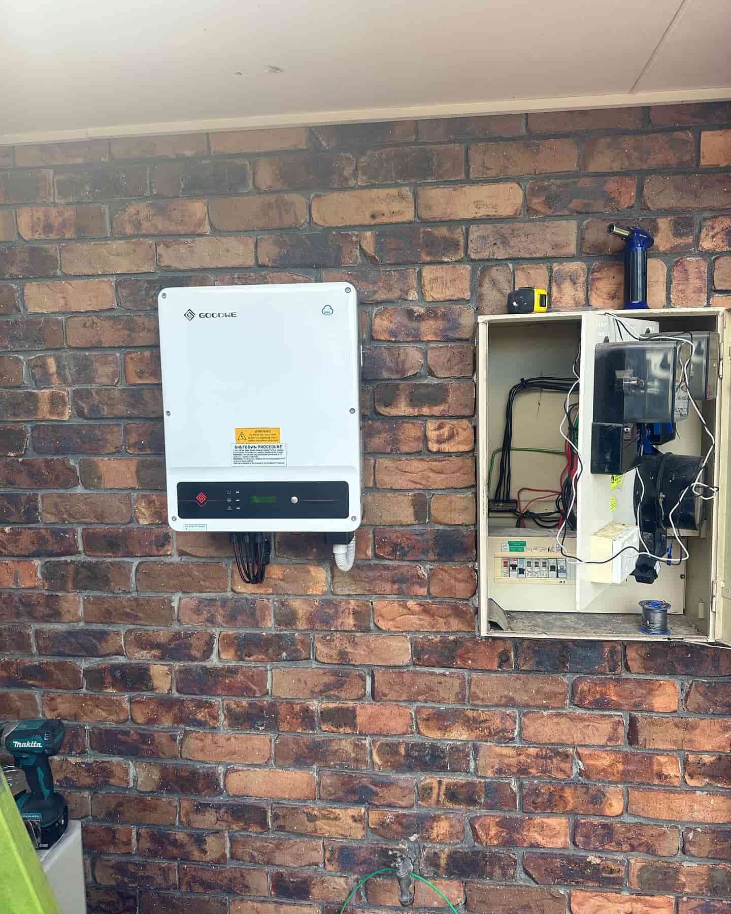 A Solar Panel Is Mounted On A Brick Wall Next To A Box — Grand Casa Electrical Solar & Batteries In Wollongbar, NSW
