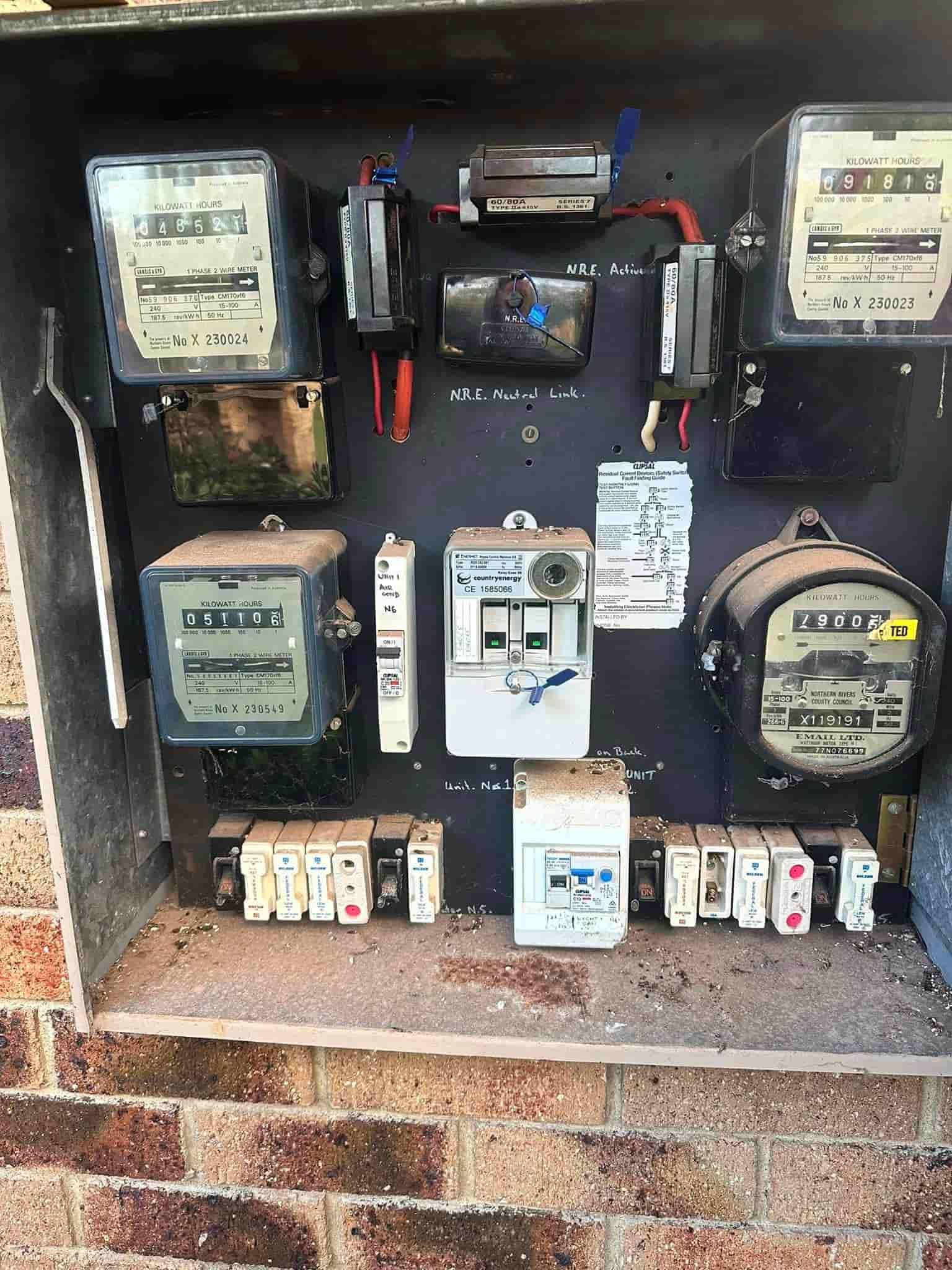 A Bunch Of Electrical Meters Are Sitting On Top Of A Brick Wall — Grand Casa Electrical & Solar In Byron Bay, NSW