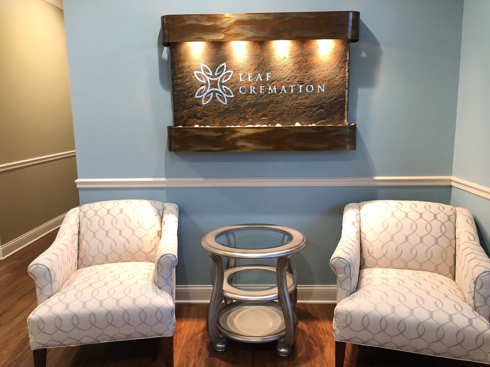 There are two chairs and a table in the room.